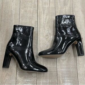 The model collective alchemy patent leather boot on black